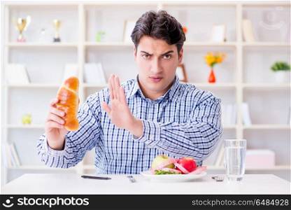 Man having dilemma between healthy food and bread in dieting con. Man having dilemma between healthy food and bread in dieting concept. Man having dilemma between healthy food and bread in dieting con