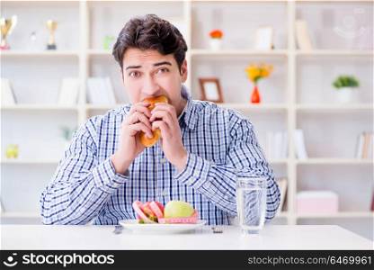 Man having dilemma between healthy food and bread in dieting concept. Man having dilemma between healthy food and bread in dieting con