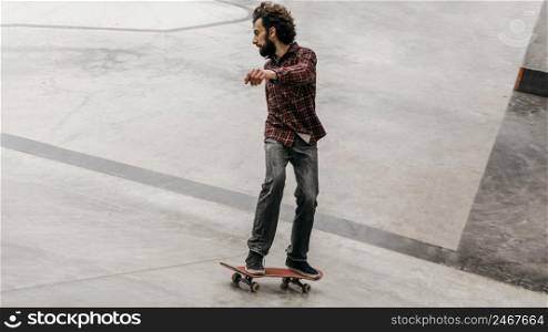 man having fun with skateboard outdoors park