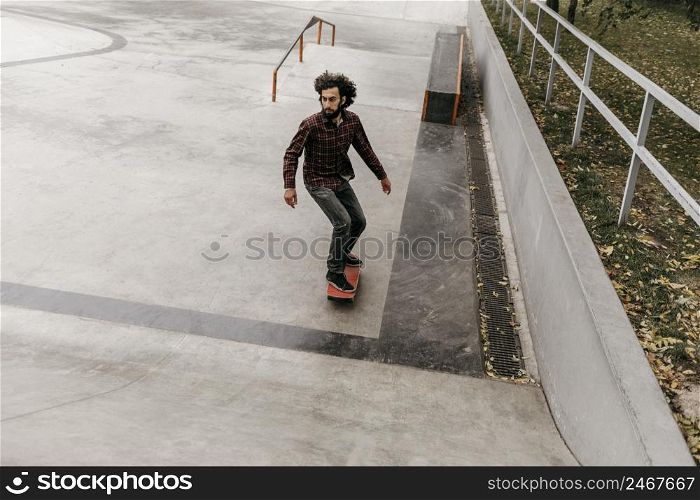 man having fun with skateboard outside