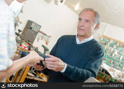 Man having his shoes repaired