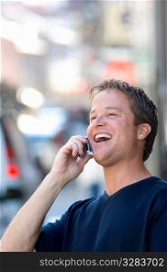 Man having lively conversation on cellphone on the street.
