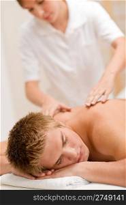 Man having luxury back massage in spa center