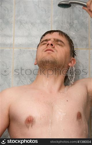 Man having shower in bathroom