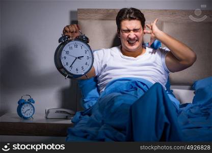 Man having trouble sleeping in bed