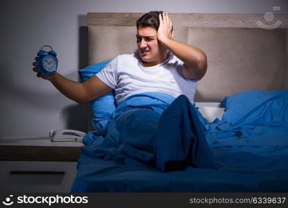 Man having trouble sleeping in bed