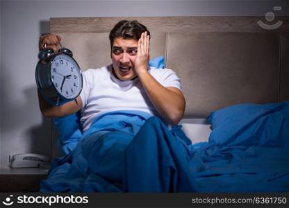 Man having trouble sleeping in bed