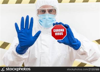 man hazmat suit with coronavirus stop sign