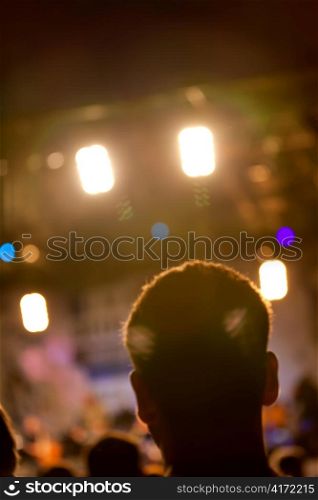 Man head silhouette with concert lights during the show