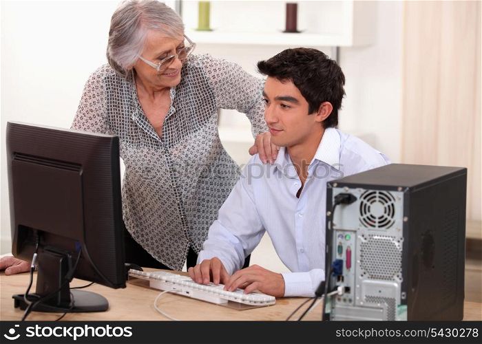 Man helping elderly woman with computer problems
