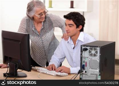 Man helping elderly woman with computer problems