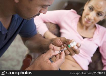 Man helping woman inject drugs to gain pregnancy (selective focus)