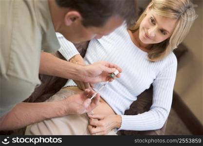 Man helping woman inject drugs to prepare for IVF treatment (selective focus)