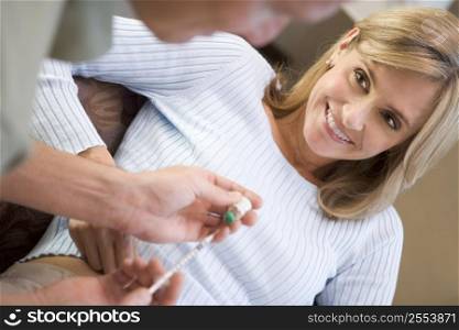 Man helping woman inject drugs to prepare for IVF treatment (selective focus)