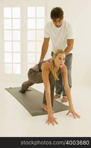 Man helping woman stretch