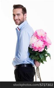 Man hiding a flower behind his back isolated on white background.