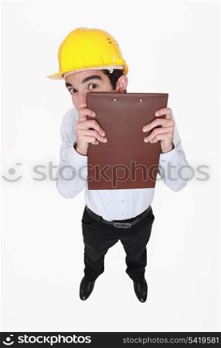 Man hiding behind a clipboard