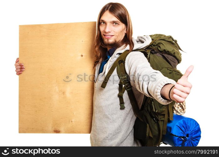 Man hiker backpacker with blank wood copy space ad. Man tourist backpacker holding blank wood plank copy space. Young guy hitchhiking with thumb up gesture. Male hiker backpacking.