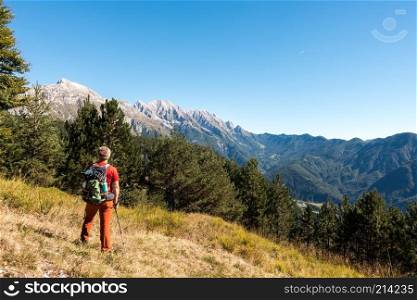Man hiker is  admiring the range mountains landscape.