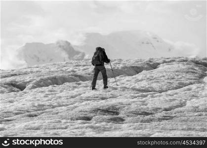 Man hiking with crampins across the Kennicott glacier in the Wrangell-St. Elias National Park, Alaska