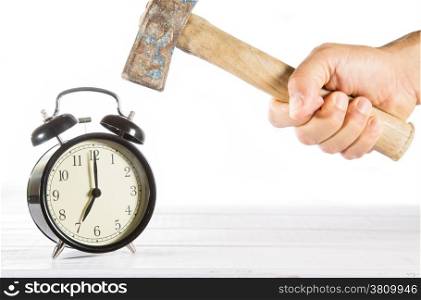 Man hitting his alarm clock with white background