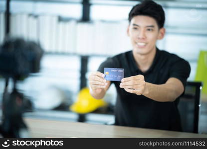 man hold credit card to camera, online marketing business concept