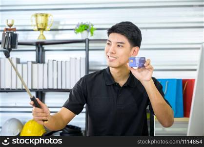 man hold credit card to camera, online marketing business concept
