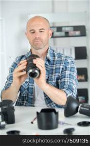 man holding a camera lens