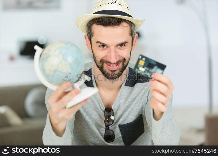 man holding a card and a globe