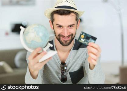 man holding a card and a globe