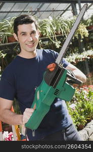 Man holding a chainsaw in a hardware store