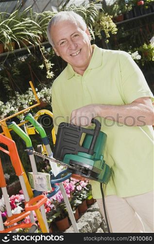 Man holding a chainsaw in a hardware store