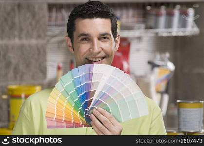 Man holding a color swatch in a hardware store