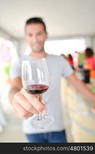 Man holding a glass of red wine