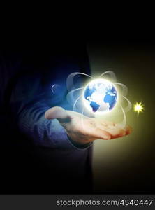 Man holding a glowing earth globe in his hands