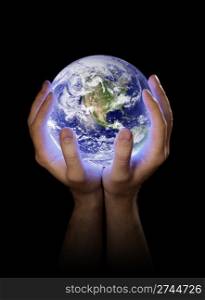 Man holding a glowing planet earth in his hands. Earth image provided by NASA.