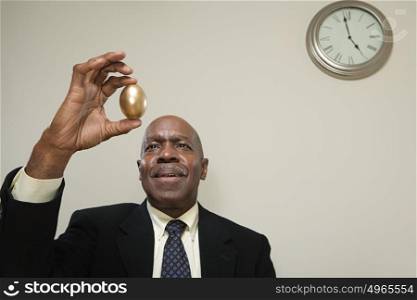 Man holding a golden egg