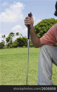 Man holding a golf club in a golf course