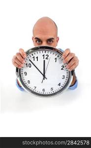 man holding a huge clock