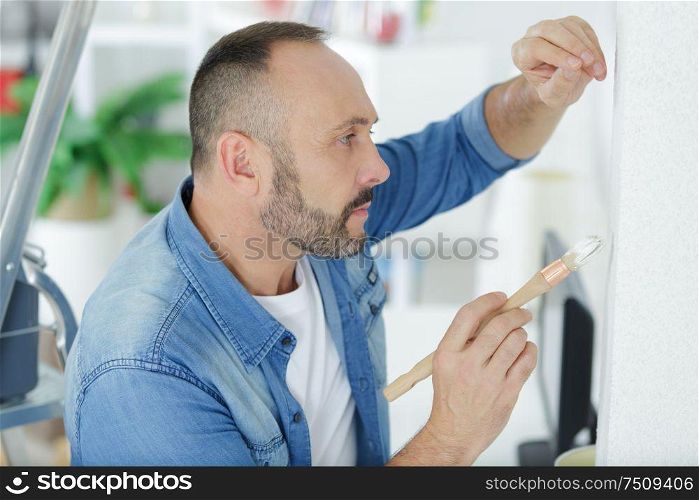 man holding a paint brush