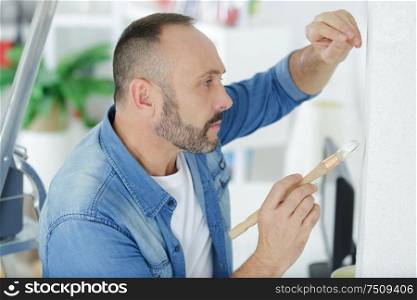 man holding a paint brush