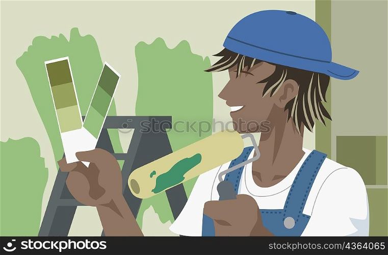 Man holding a paint roller and looking at color swatches