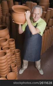 Man holding a pot in garden center