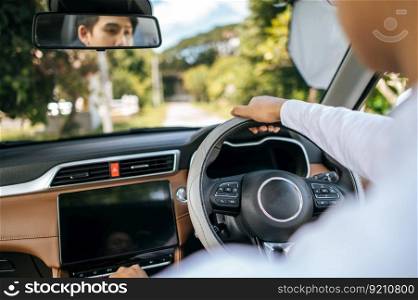 man holding a steering wheel in a car to drive