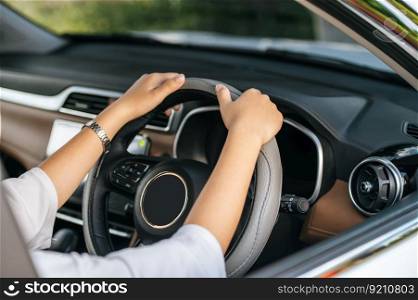 man holding a steering wheel in a car to drive