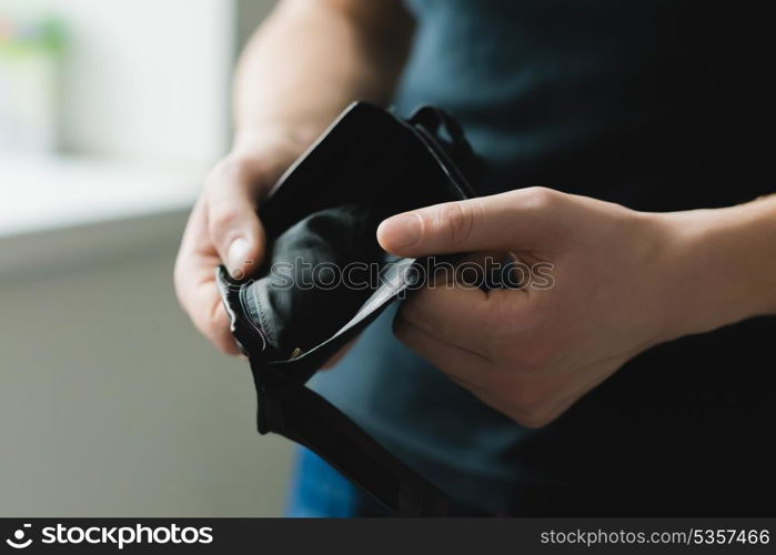 Man holding an empty wallet