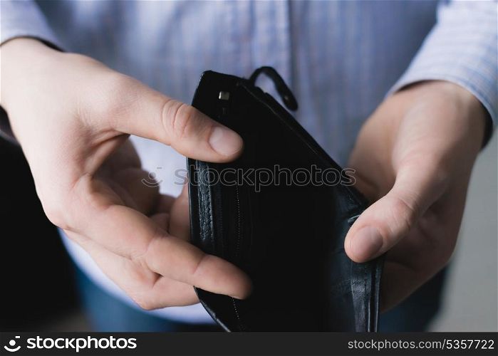 Man holding an empty wallet