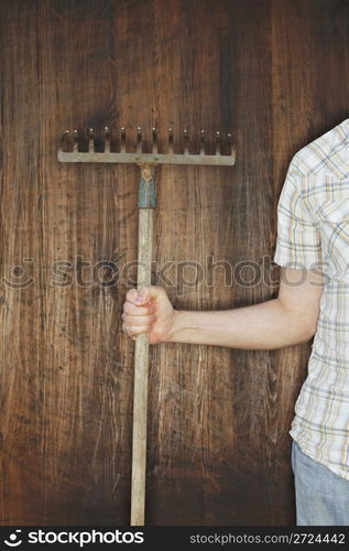 Man holding an old rake