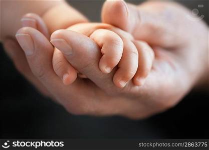 Man Holding Baby&acute;s Hand