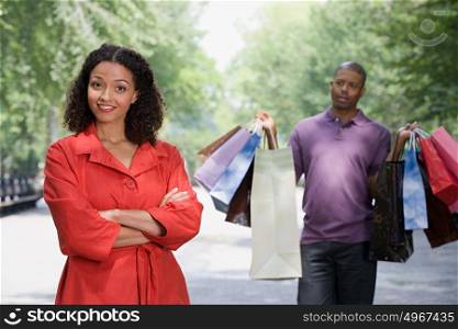 Man holding bags for woman